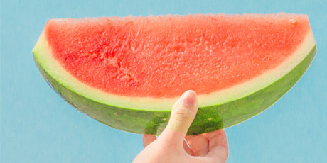 holding ripe watermelon